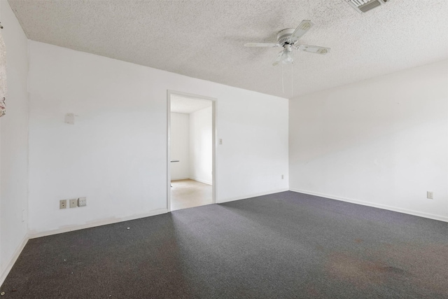 empty room with a textured ceiling, carpet flooring, and ceiling fan