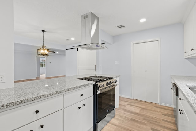 kitchen featuring appliances with stainless steel finishes, island exhaust hood, light wood-type flooring, white cabinets, and hanging light fixtures