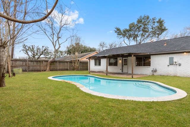 view of swimming pool with a yard and a patio