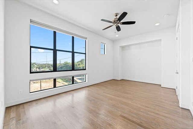 empty room featuring light wood-type flooring and ceiling fan