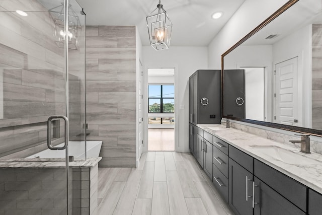 bathroom featuring separate shower and tub and vanity