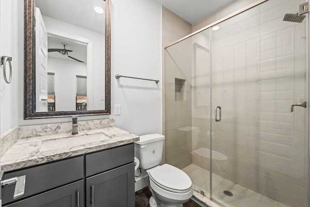 bathroom featuring toilet, vanity, and walk in shower