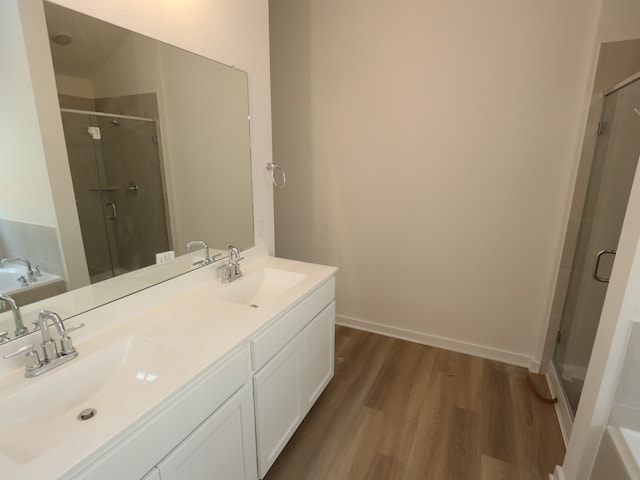 31911 Splendor Dr, Fulshear, TX 77441 - full bath featuring wood finished floors, a stall shower, and a garden tub