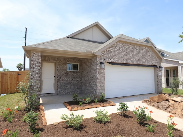 31911 Splendor Dr, Fulshear, TX 77441 - ranch-style home featuring a garage, fence, brick siding, board and batten siding, and driveway