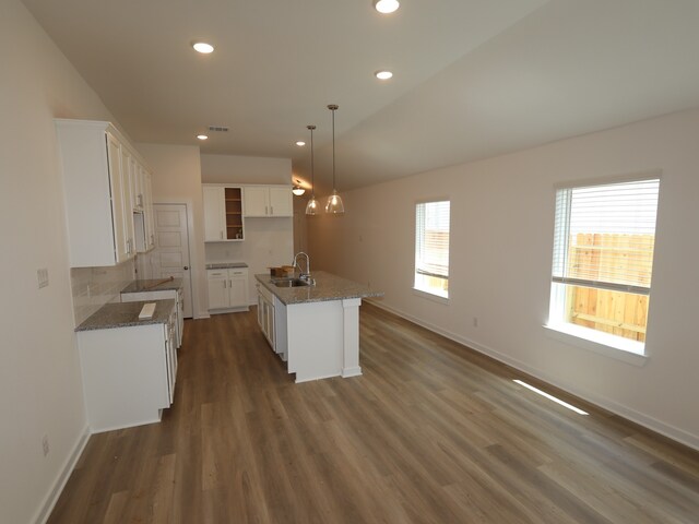 31911 Splendor Dr, Fulshear, TX 77441 - kitchen with a sink, an island with sink, recessed lighting, baseboards, and dark wood-style flooring