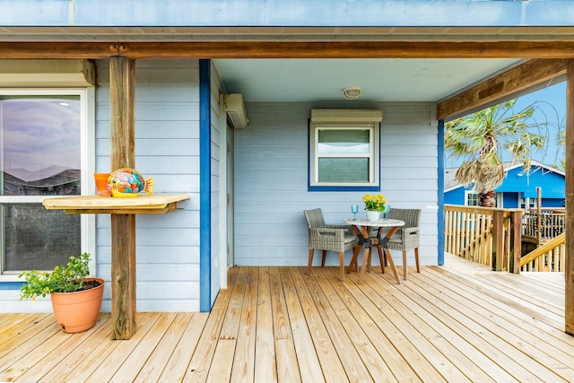 wooden terrace featuring a wall unit AC