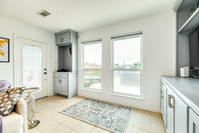 doorway featuring light tile patterned flooring