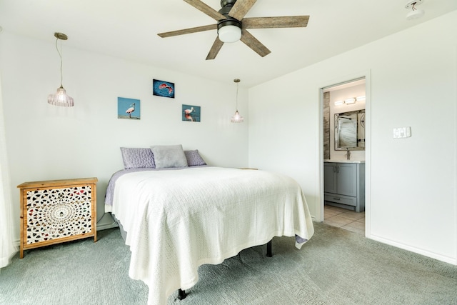 carpeted bedroom with ceiling fan, sink, and ensuite bath