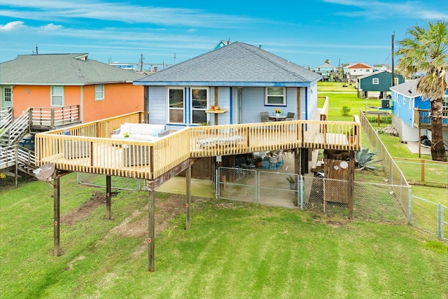 back of house with a deck and a yard