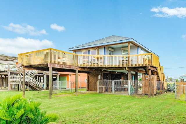 rear view of property featuring a yard and a deck