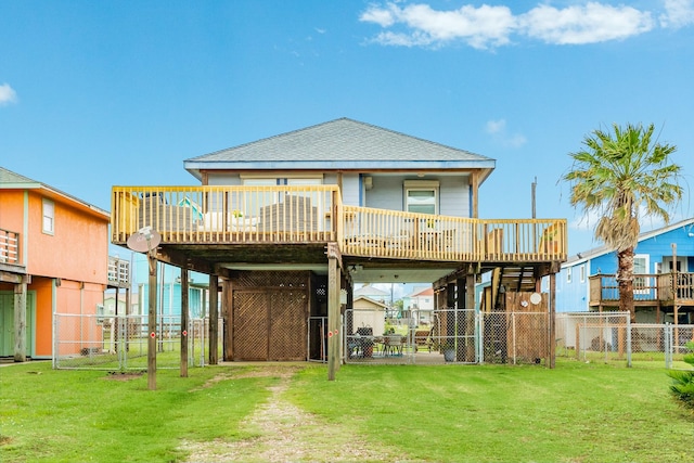 rear view of property featuring a lawn and a wooden deck