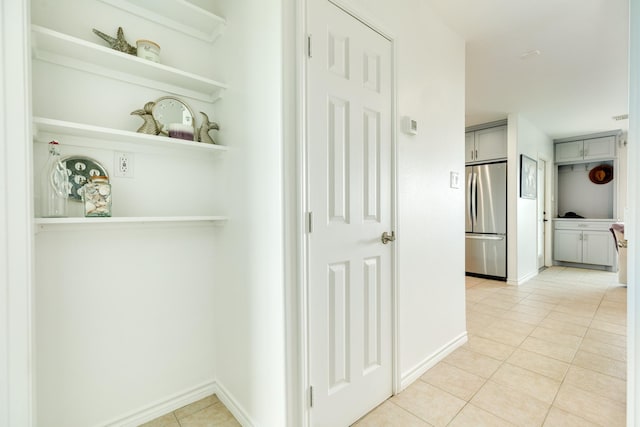 hallway featuring light tile patterned floors