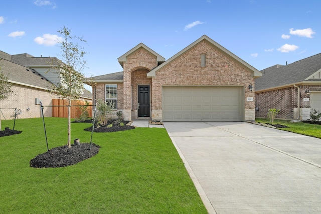 view of front of home featuring a front yard and a garage