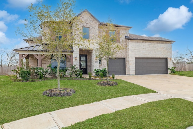 view of front of property with a front yard and a garage