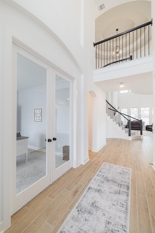 interior space featuring a high ceiling and french doors