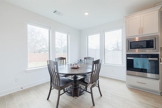 dining area with light hardwood / wood-style floors