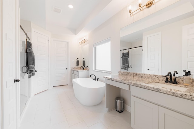 bathroom featuring separate shower and tub, vanity, and tile patterned flooring