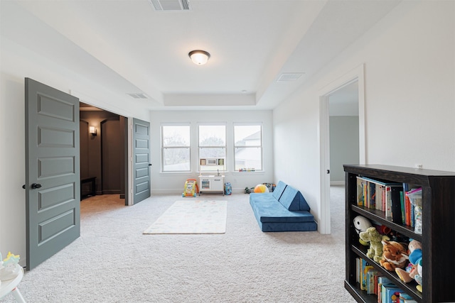 game room featuring light carpet and a raised ceiling