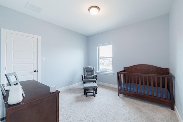 carpeted bedroom featuring a crib