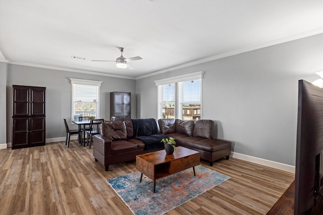 1623 Bay Meadows St, Galveston, TX 77554 - living area featuring visible vents, a ceiling fan, light wood-style floors, crown molding, and baseboards