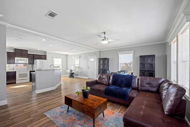 1623 Bay Meadows St, Galveston, TX 77554 - living room featuring ornamental molding, a healthy amount of sunlight, visible vents, and ceiling fan