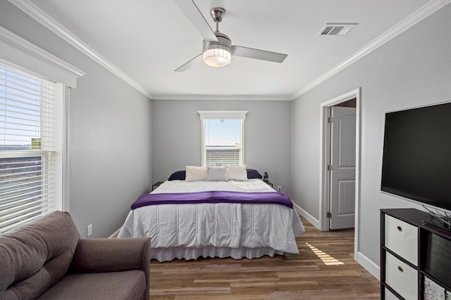 1623 Bay Meadows St, Galveston, TX 77554 - bedroom featuring a ceiling fan, wood finished floors, visible vents, baseboards, and crown molding