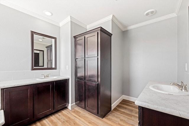 1623 Bay Meadows St, Galveston, TX 77554 - bathroom featuring a sink, two vanities, and wood finished floors