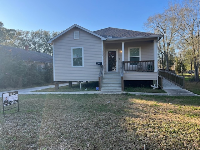 bungalow-style house with covered porch and a front yard