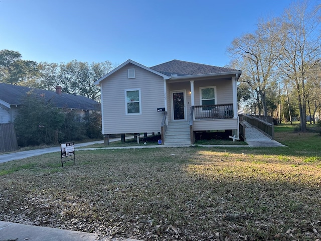 bungalow-style house with covered porch and a front lawn