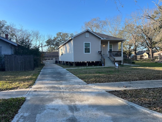 view of front of property with covered porch and a garage