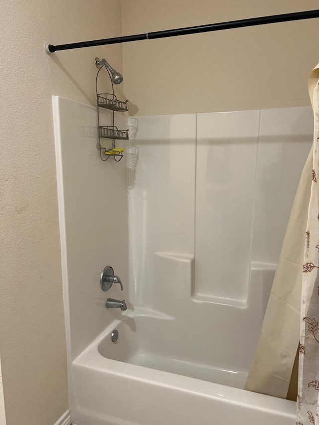 bathroom featuring shower / bath combo with shower curtain