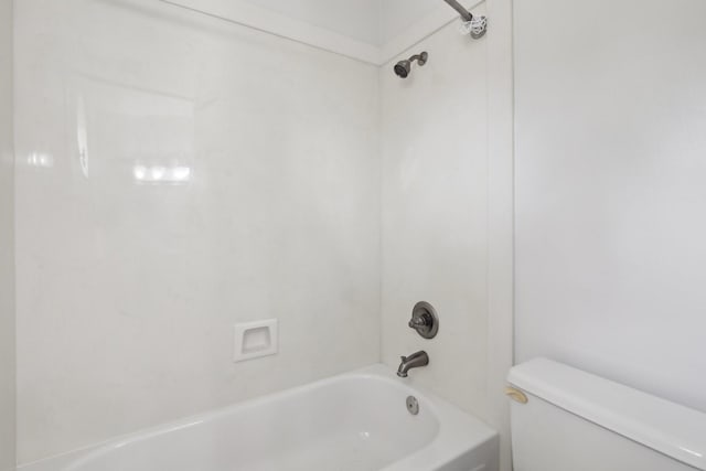 bathroom featuring toilet and tub / shower combination