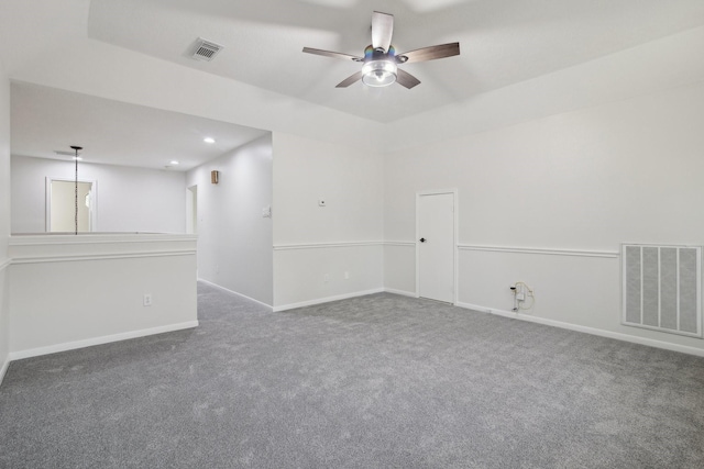 spare room featuring ceiling fan and carpet