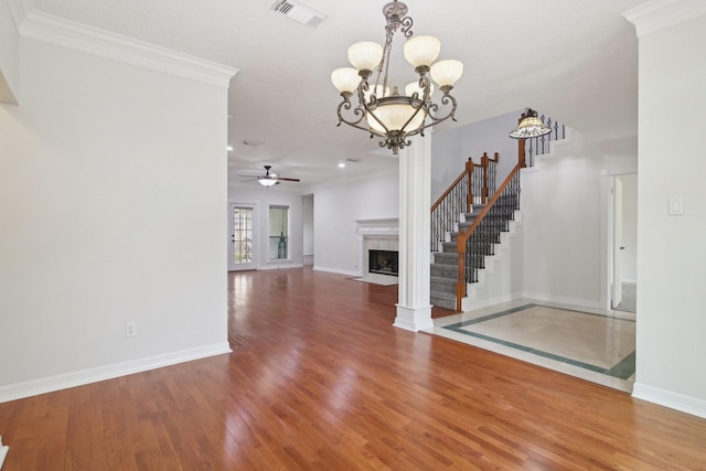 interior space with ornamental molding, hardwood / wood-style floors, and ceiling fan with notable chandelier