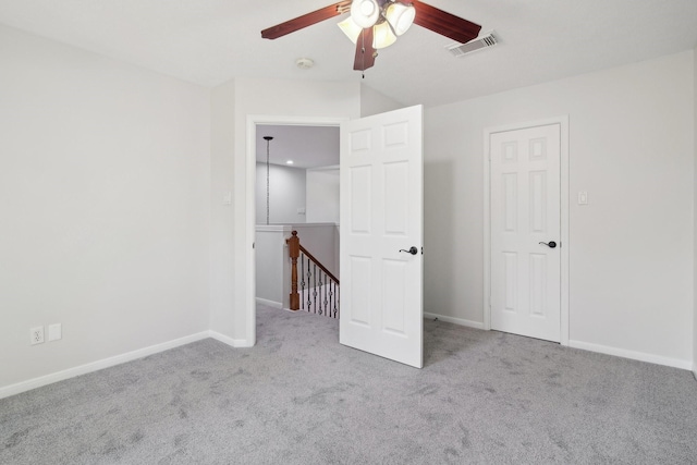 unfurnished bedroom with ceiling fan and light carpet