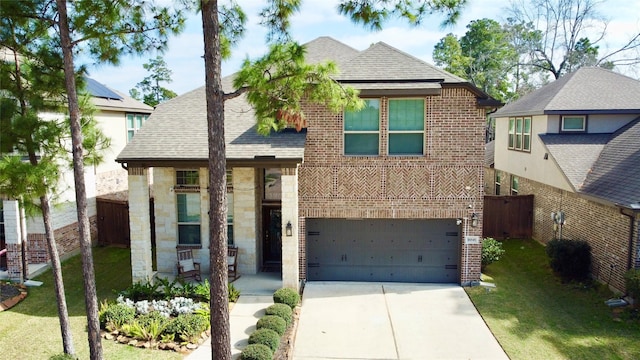 view of front of home with a garage, brick siding, a shingled roof, concrete driveway, and a front yard