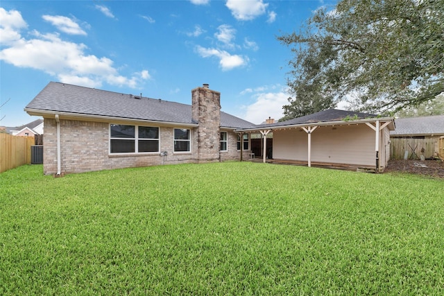 back of property featuring a yard and cooling unit