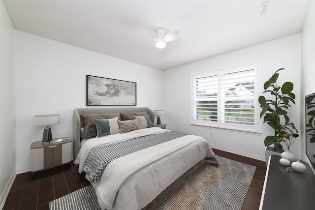 bedroom with ceiling fan and dark hardwood / wood-style flooring