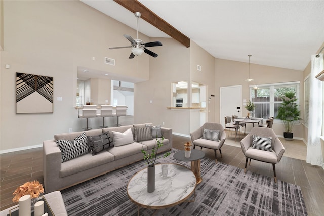 living room featuring ceiling fan and vaulted ceiling with beams