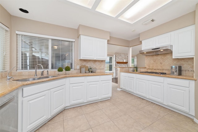 kitchen featuring decorative backsplash, white cabinetry, sink, and stainless steel gas stovetop