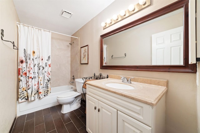 full bathroom featuring shower / bathtub combination with curtain, vanity, and toilet