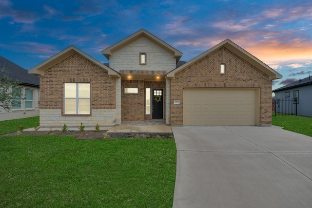 view of front of house with a garage and a lawn