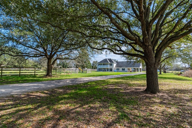 view of yard featuring fence and driveway