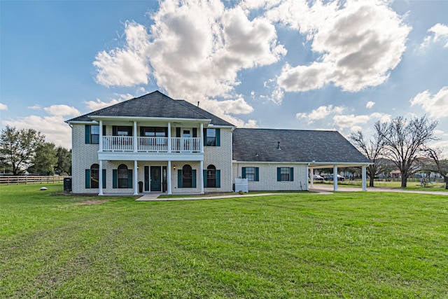 back of house with brick siding, a yard, a balcony, a carport, and cooling unit