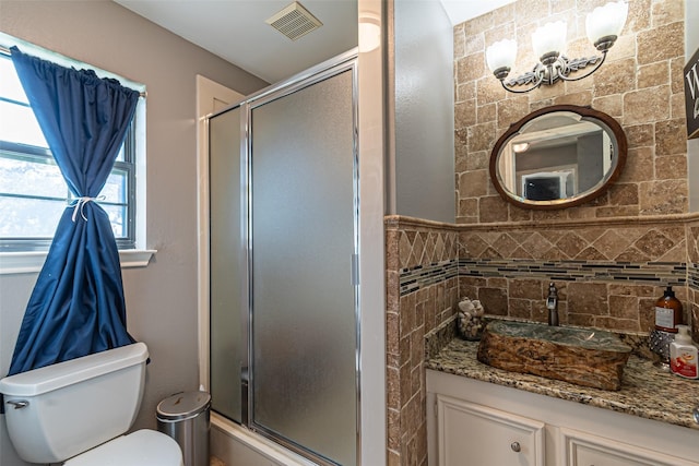 full bath featuring toilet, a stall shower, visible vents, and vanity