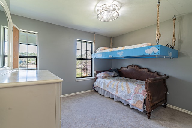 bedroom with carpet floors and baseboards