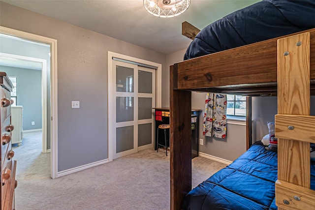 carpeted bedroom featuring baseboards