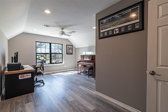 home office featuring visible vents, vaulted ceiling, baseboards, and wood finished floors