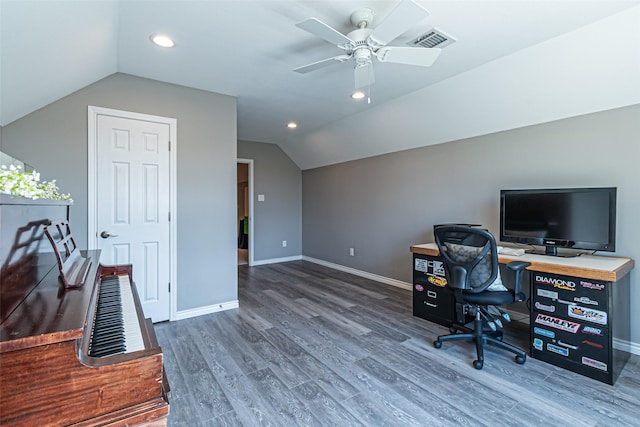 office area featuring wood finished floors, a ceiling fan, visible vents, vaulted ceiling, and baseboards