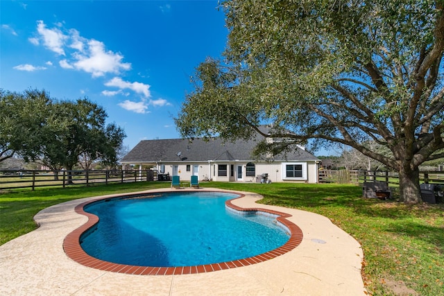 view of swimming pool with a yard, fence, and a fenced in pool